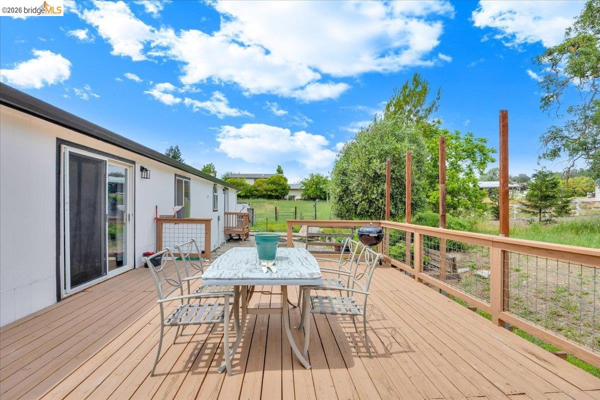 4419 Little John Road Copperopolis, CA 95228 - Photo 23 of 43 Expansive outdoor deck featuring wood-finish flooring and a wood railing with wire infill
