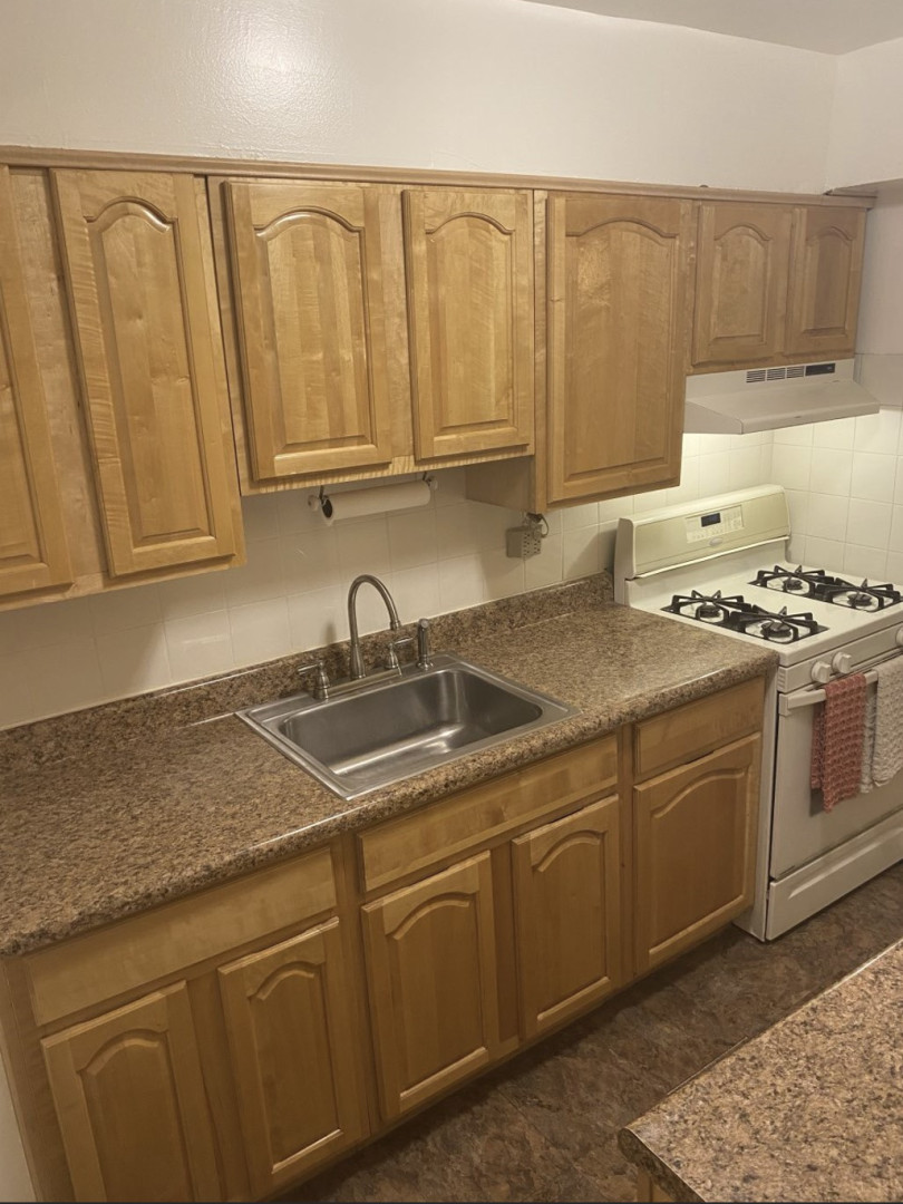 2385 Barker Avenue, Unit 5L Bronx, NY 10467 - Photo 4 of 15 a kitchen with stainless steel appliances granite countertop a sink stove and cabinets