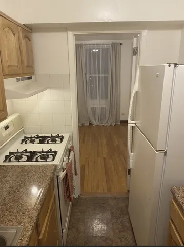 a kitchen with a stove and a refrigerator