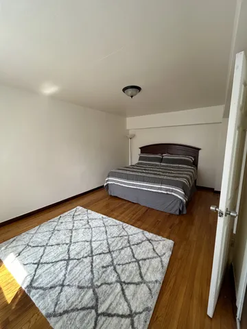 a view of an empty room and wooden floor