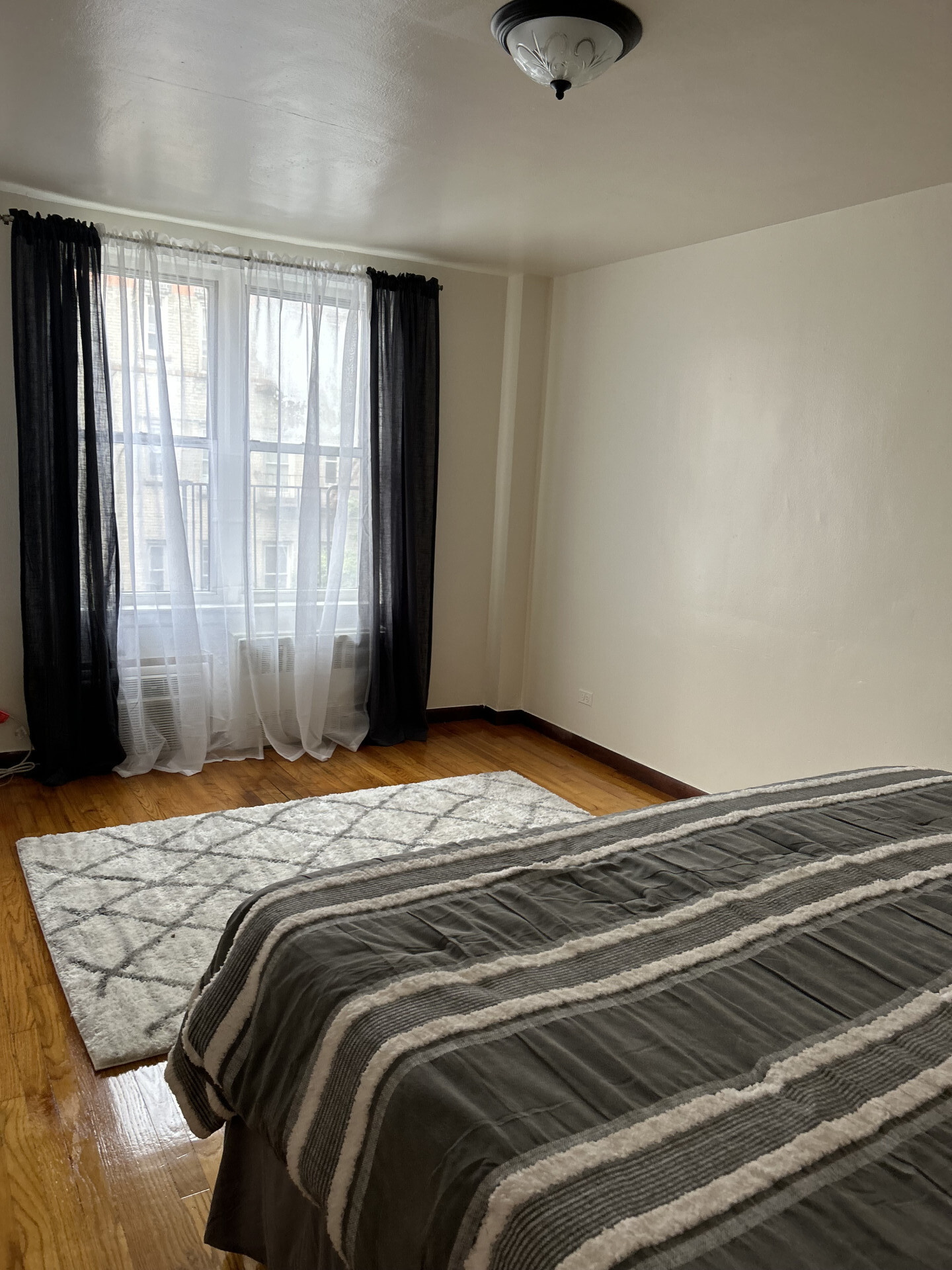 2385 Barker Avenue, Unit 5L Bronx, NY 10467 - Photo 7 of 15 a bedroom with a bed and a window