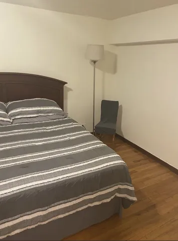 a bedroom with a bed and a table
