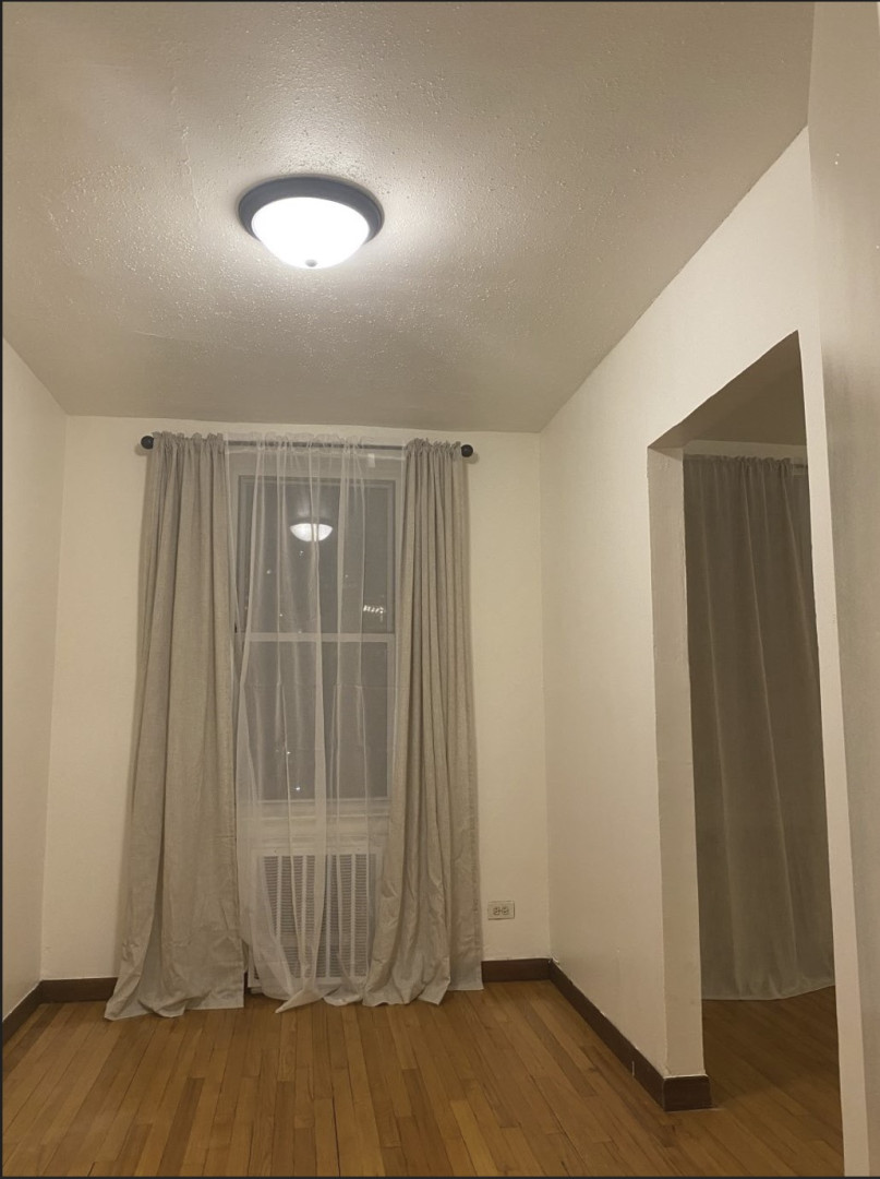 2385 Barker Avenue, Unit 5L Bronx, NY 10467 - Photo 10 of 15 an empty room with wooden floor and windows