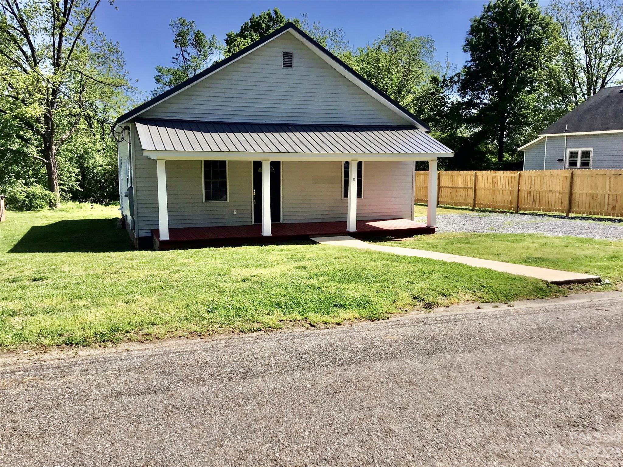 a front view of a house with yard and green space