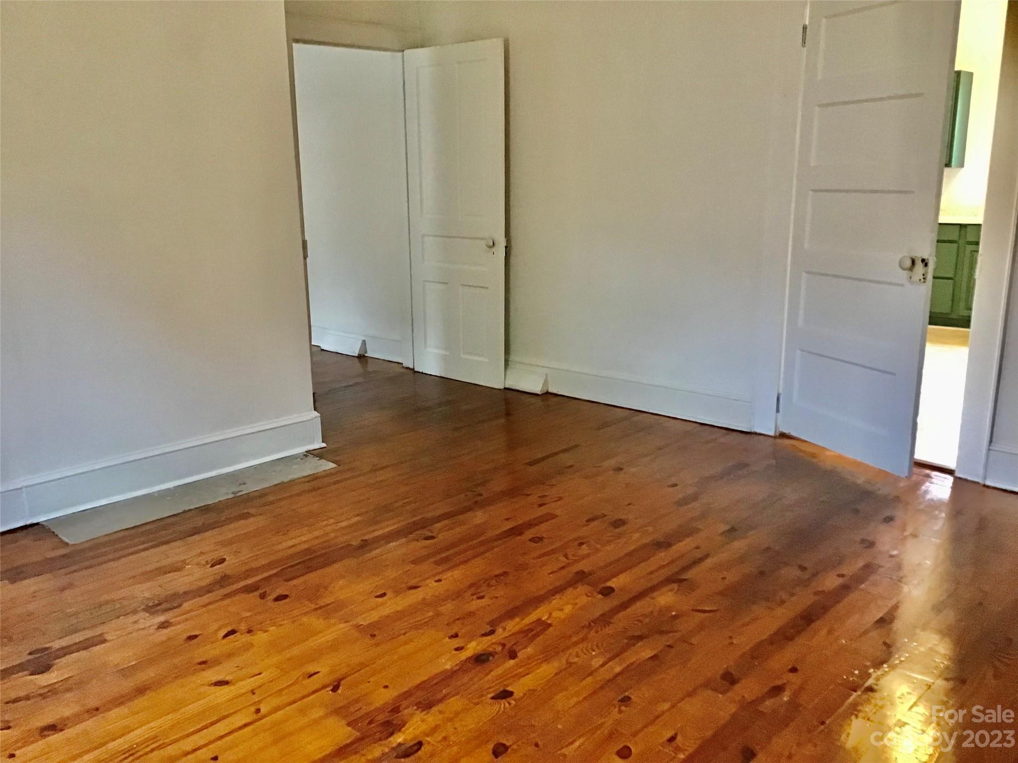 101 Alexander Road Stony Point, NC 28678 - Photo 11 of 15 an empty room with wooden floor and windows