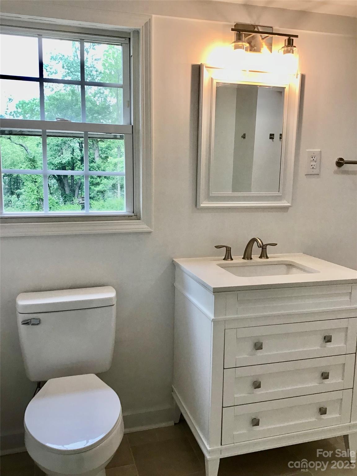 101 Alexander Road Stony Point, NC 28678 - Photo 12 of 15 a bathroom with a toilet sink vanity and mirror