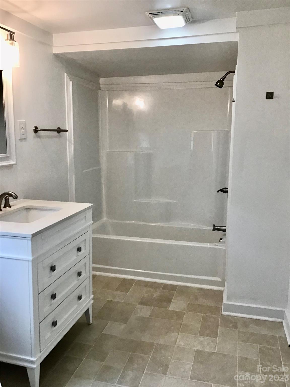 101 Alexander Road Stony Point, NC 28678 - Photo 13 of 15 a bathroom with a bathtub vanity and a shower