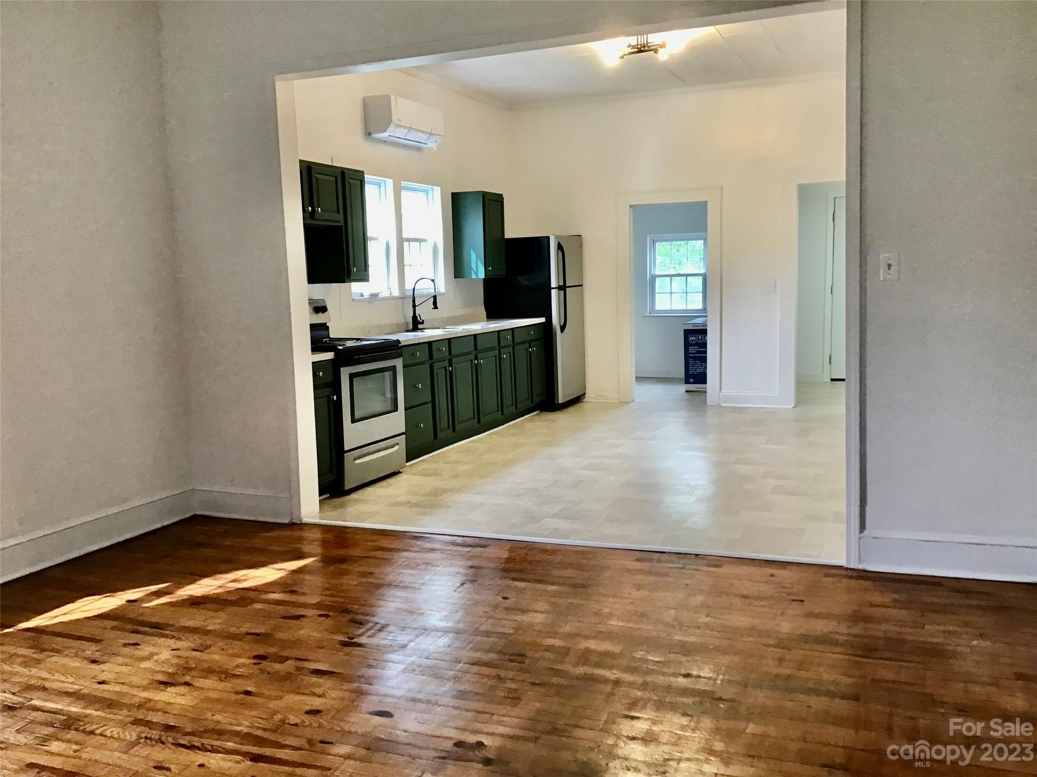 101 Alexander Road Stony Point, NC 28678 - Photo 2 of 15 a view of a kitchen with kitchen island wooden floors wooden floor and counter top space