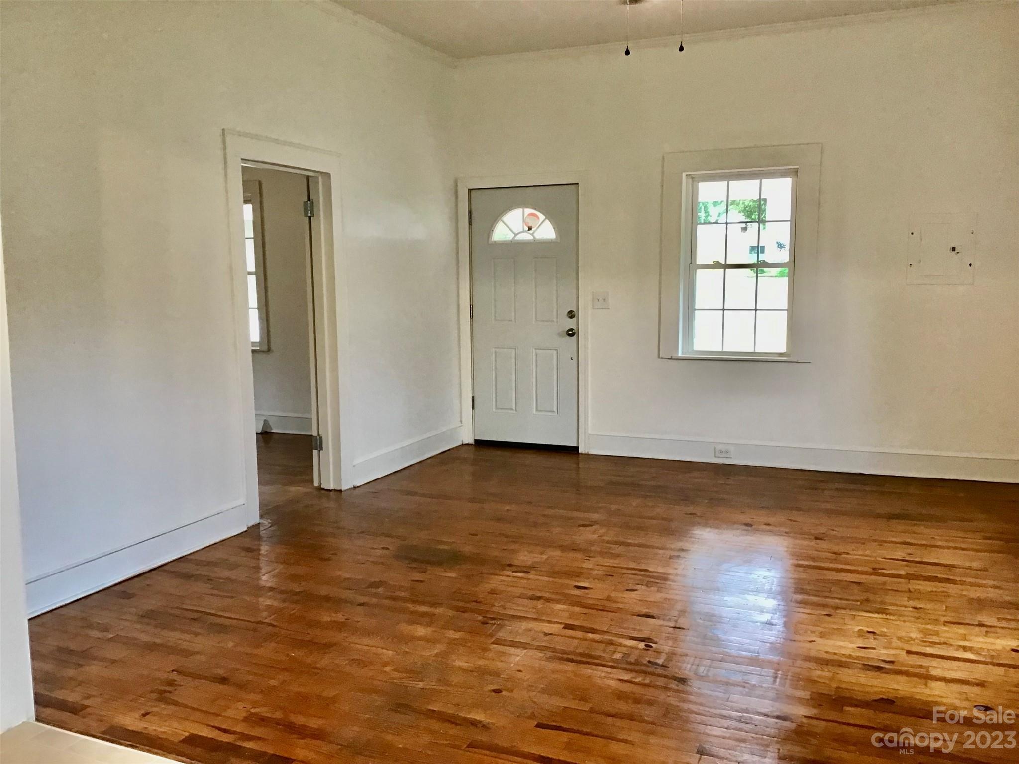 101 Alexander Road Stony Point, NC 28678 - Photo 3 of 15 an empty room with wooden floor and windows