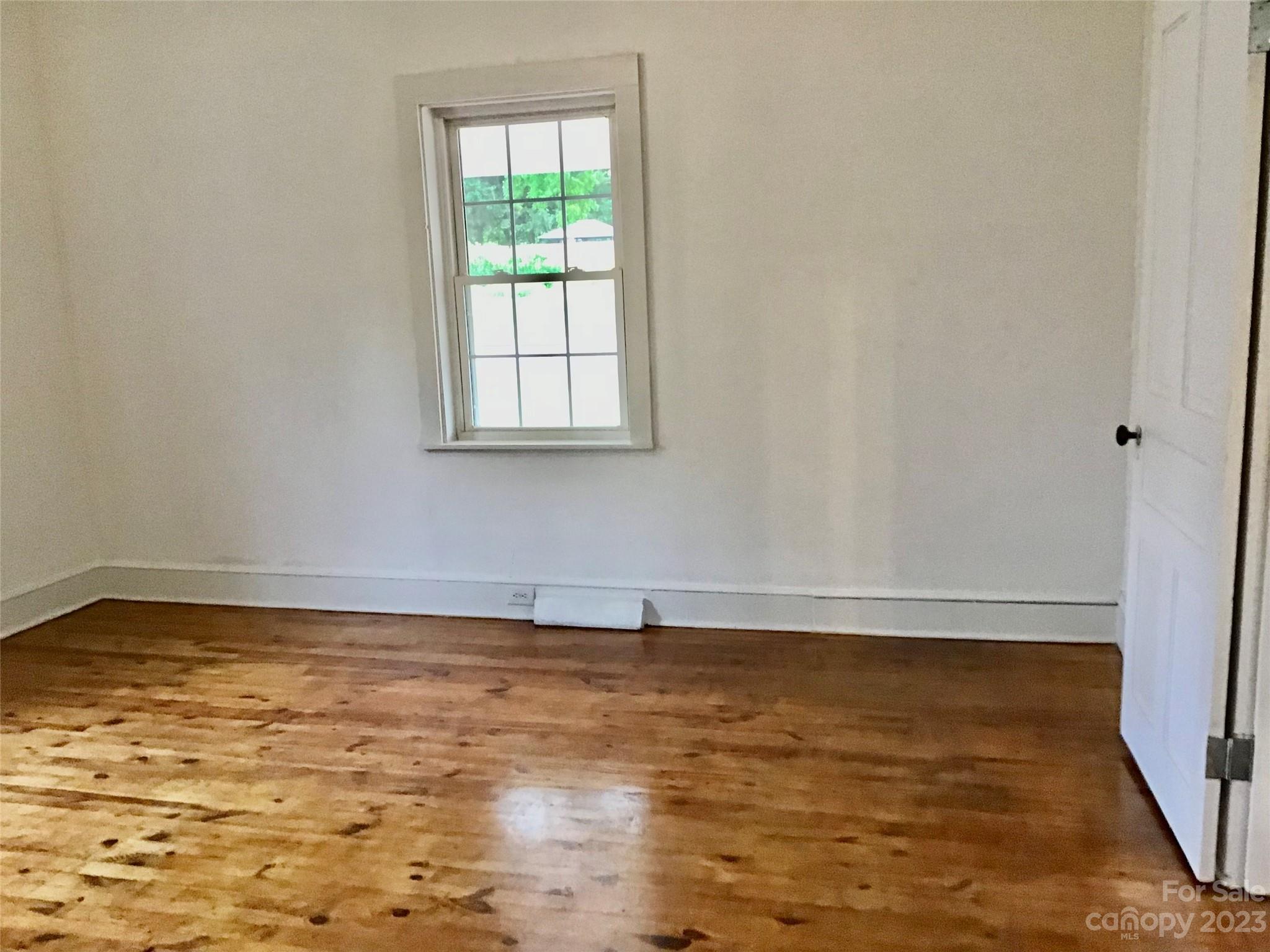 101 Alexander Road Stony Point, NC 28678 - Photo 10 of 15 a view of empty room with wooden floor and fan