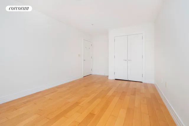 a bedroom with a bed and a lamp on table