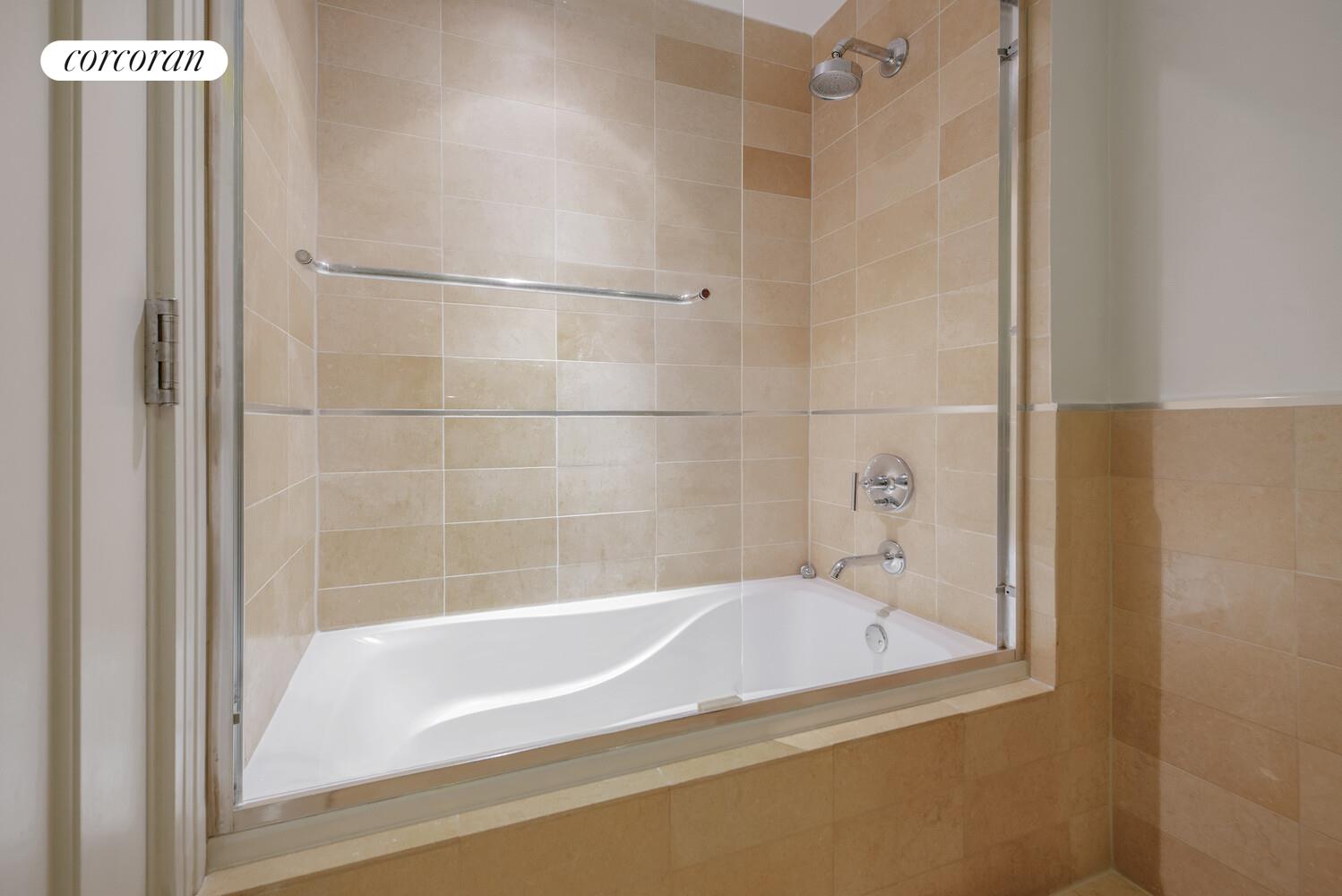 64-05 Yellowstone Boulevard, Unit 213 Queens, NY 11375 - Photo 13 of 15 a bathroom with a bathtub