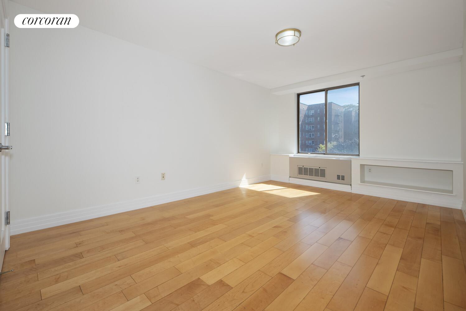 64-05 Yellowstone Boulevard, Unit 213 Queens, NY 11375 - Photo 9 of 15 an empty room with windows