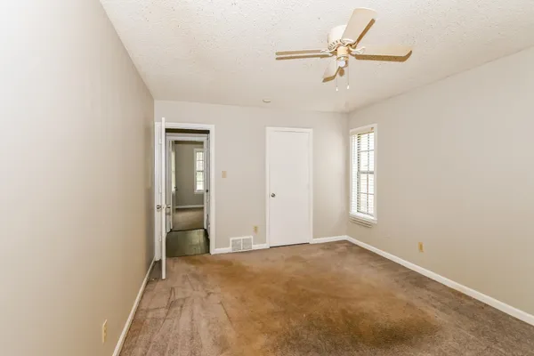 a view of a livingroom with a ceiling fan and window