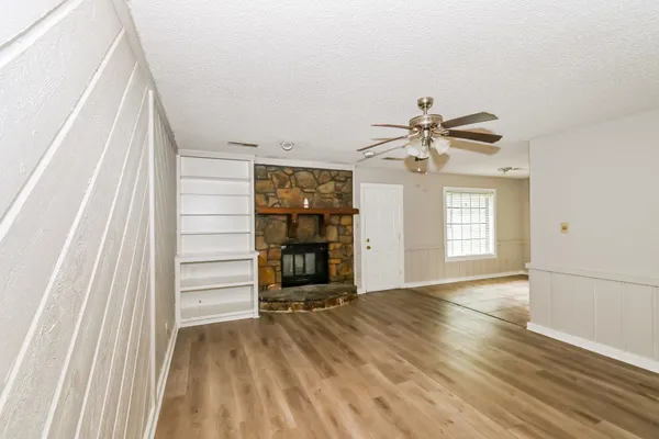 wooden floor in an empty room with a window
