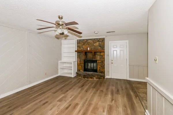 wooden floor in an empty room with a fireplace