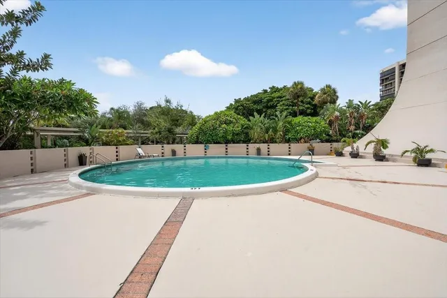 a view of a swimming pool with a yard