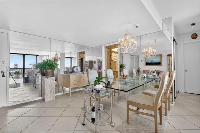 a view of a dining room with furniture and chandelier