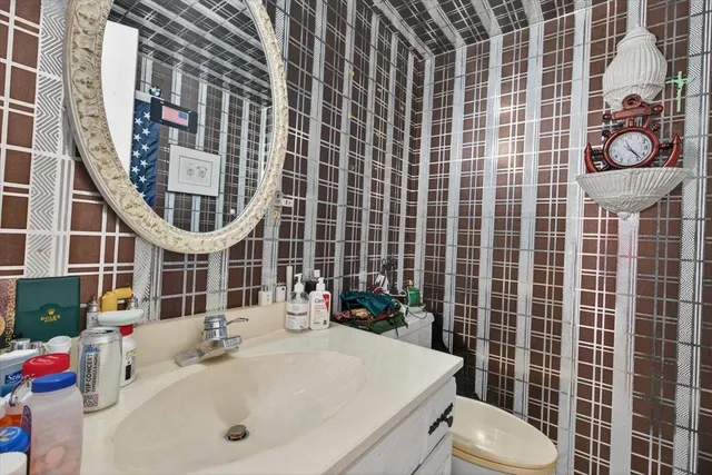a bathroom with a sink toilet and shower