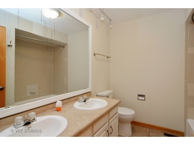 239 Leith Way Cary, IL 60013 - Photo 14 of 16 a bathroom with a sink a toilet and shower