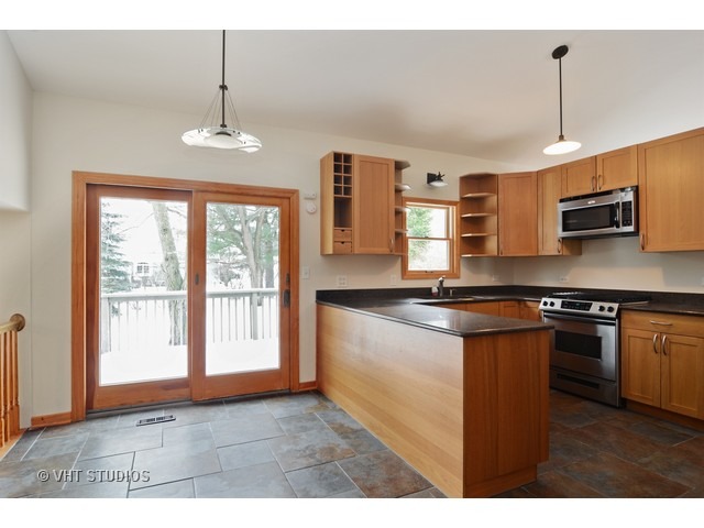239 Leith Way Cary, IL 60013 - Photo 3 of 16 a kitchen with stainless steel appliances granite countertop a stove a refrigerator a sink and a microwave