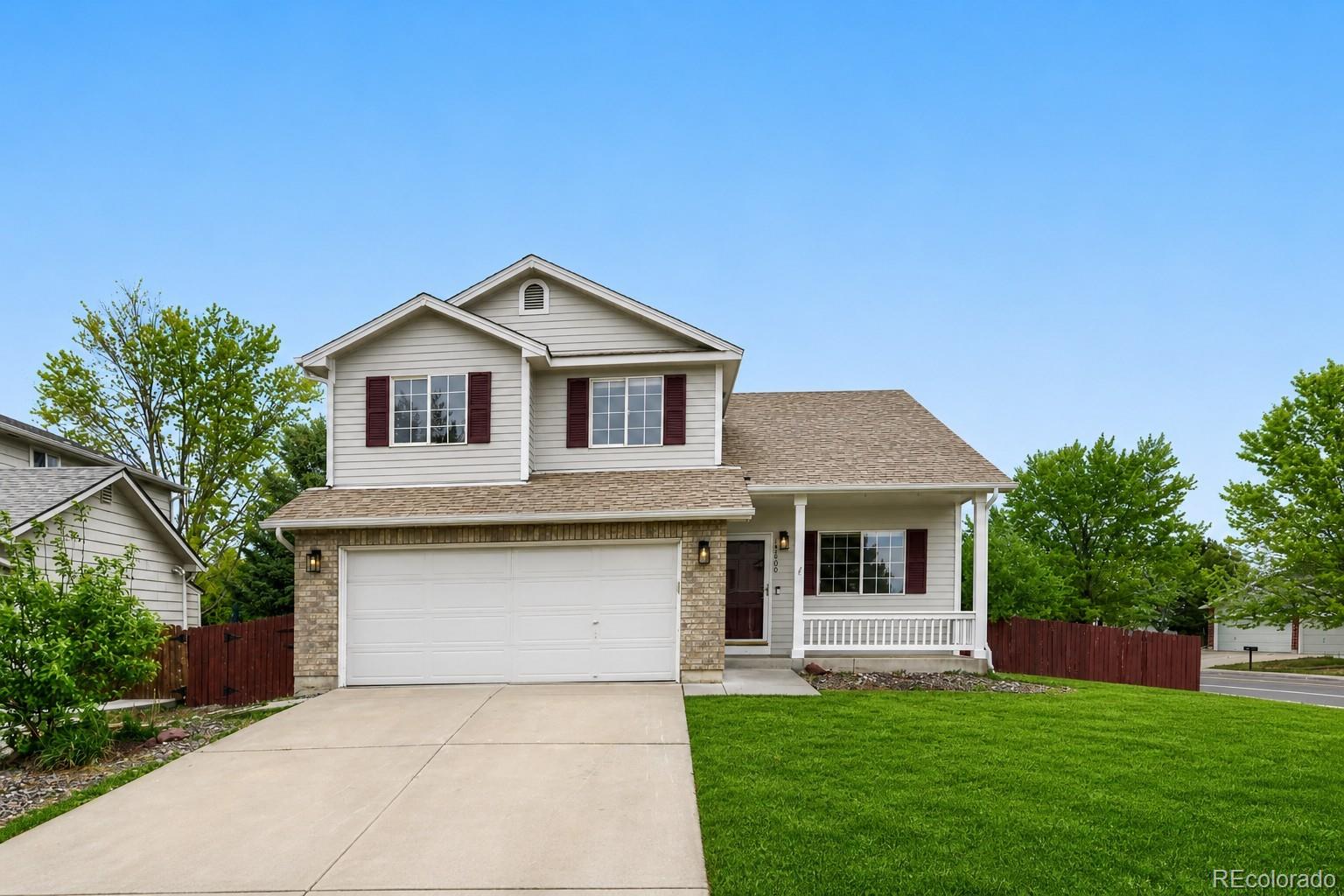 13400 Raritan Street Denver, CO 80234 - Photo 1 of 32 a front view of a house with a garden and yard