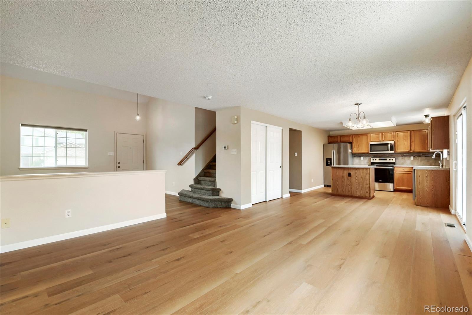 13400 Raritan Street Denver, CO 80234 - Photo 11 of 32 a view of kitchen with furniture and wooden floor