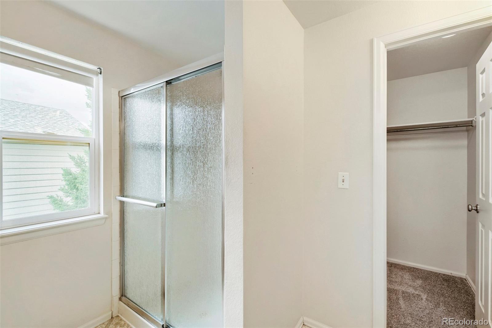 13400 Raritan Street Denver, CO 80234 - Photo 23 of 32 a bathroom with a glass shower door