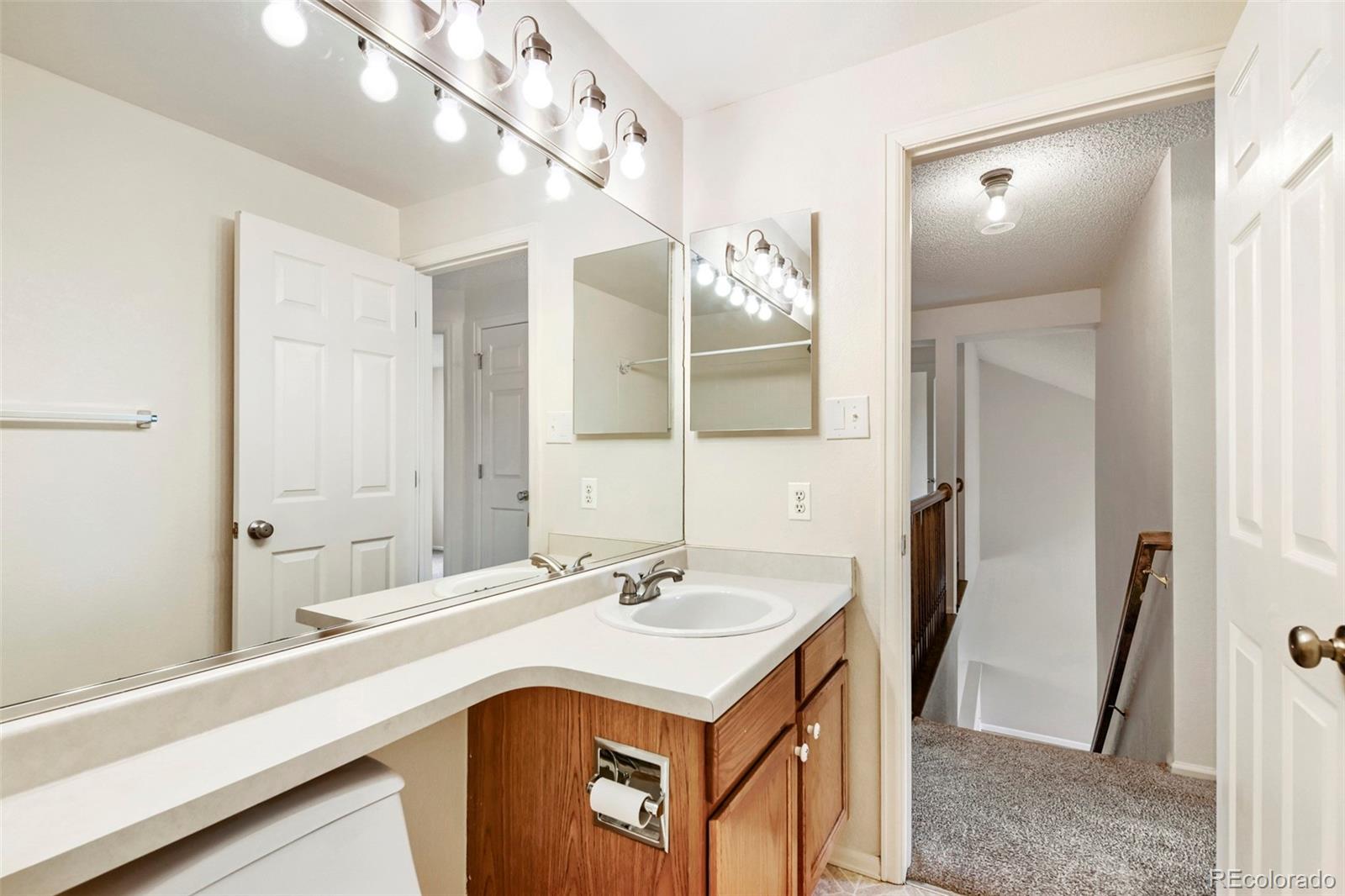13400 Raritan Street Denver, CO 80234 - Photo 30 of 32 a bathroom with a sink and a mirror