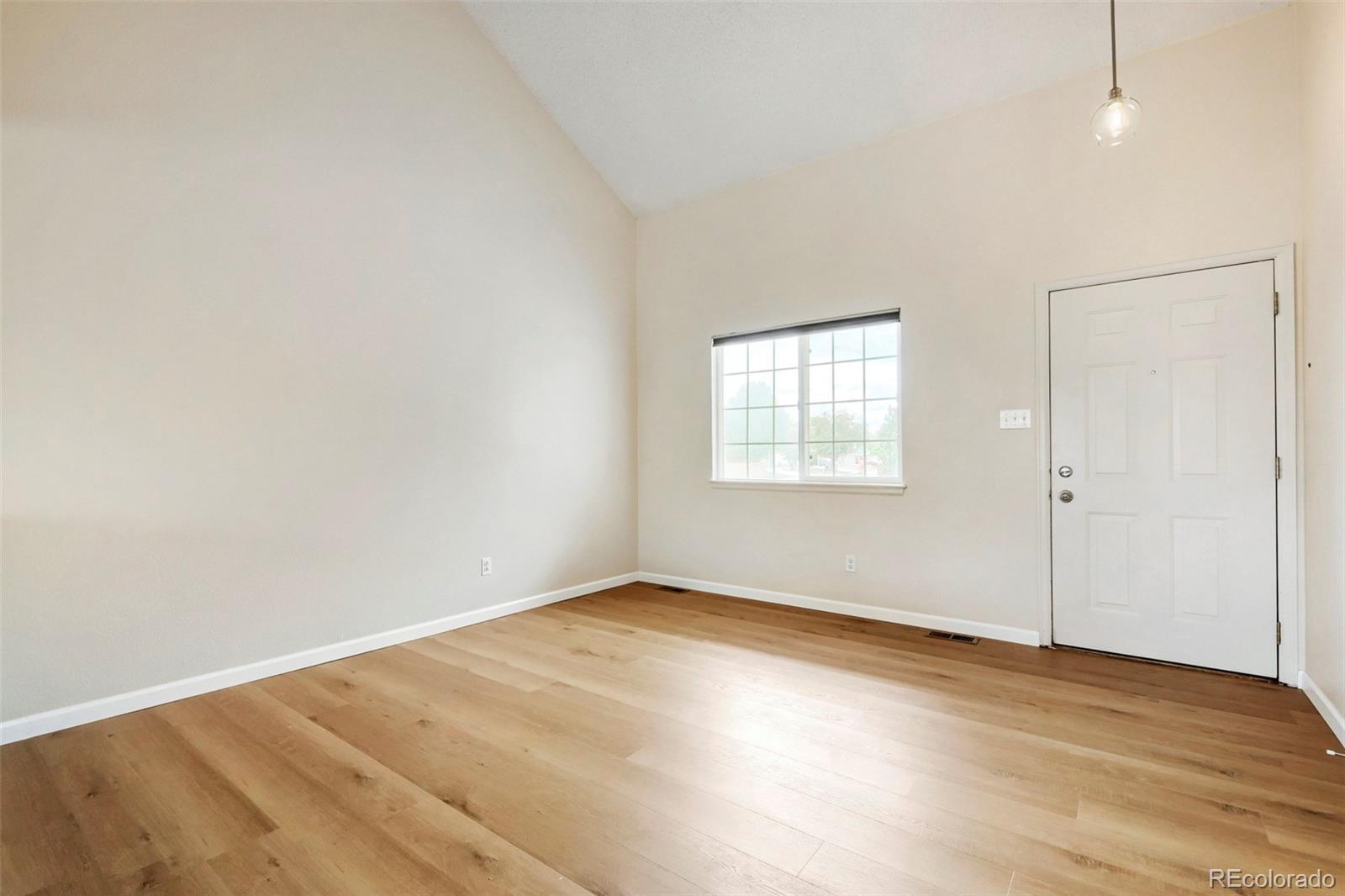 13400 Raritan Street Denver, CO 80234 - Photo 6 of 32 an empty room with wooden floor closet and windows