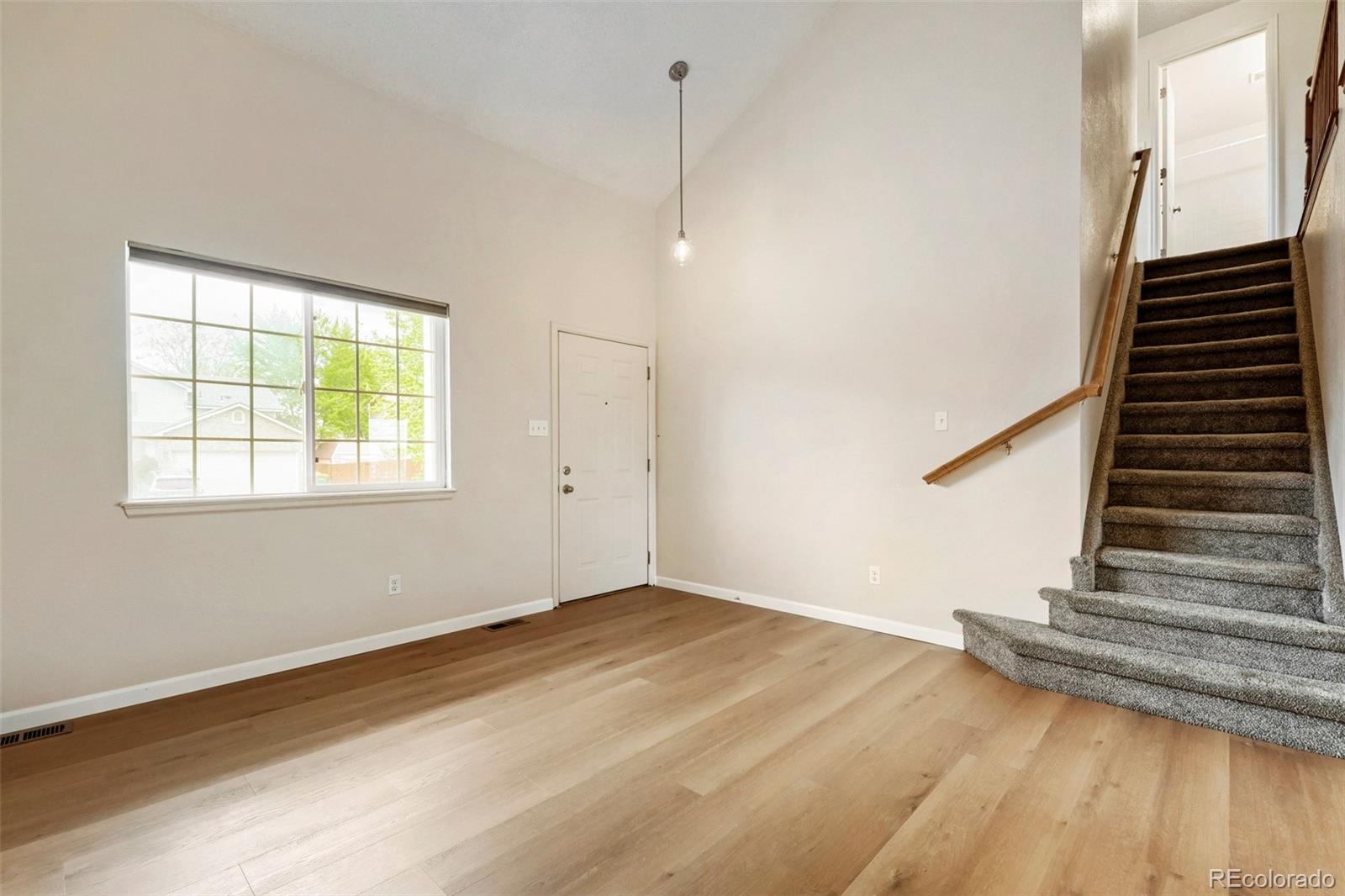 13400 Raritan Street Denver, CO 80234 - Photo 7 of 32 a view of a room with wooden floor and white walls