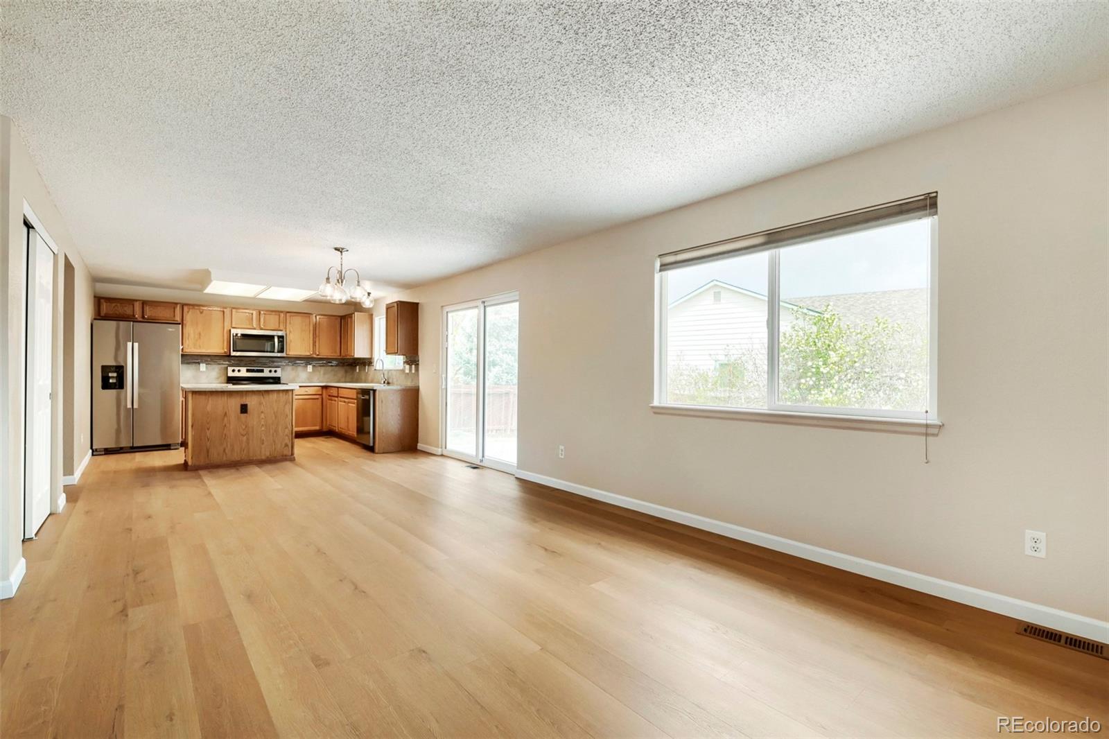 13400 Raritan Street Denver, CO 80234 - Photo 10 of 32 a view of a kitchen with furniture and windows