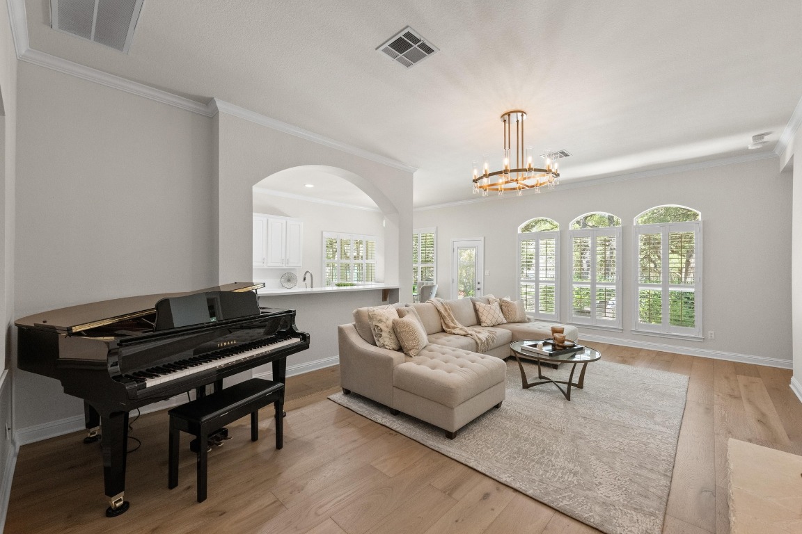 a living room with furniture fireplace and a large window