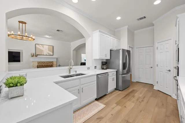 a kitchen with a sink stainless steel appliances and cabinets