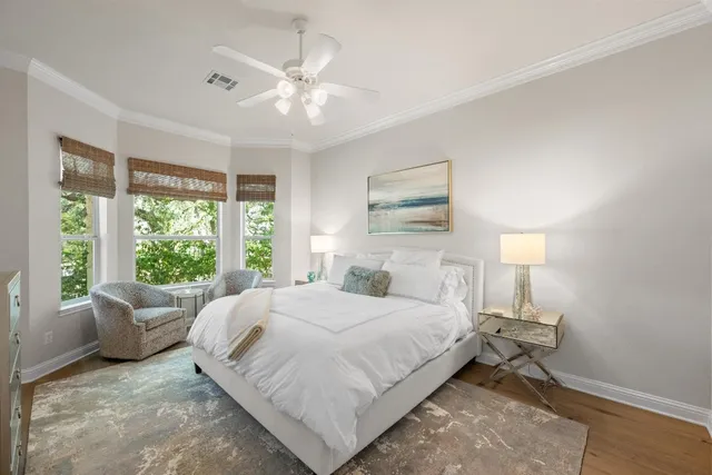 a bedroom with a large bed and a chandelier