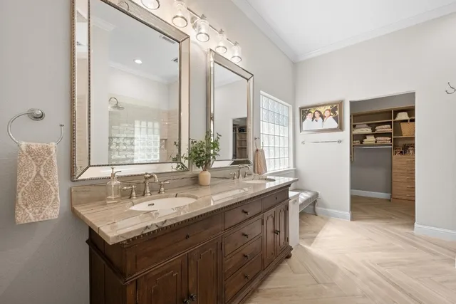 a bathroom with a granite countertop sink a toilet and a large mirror
