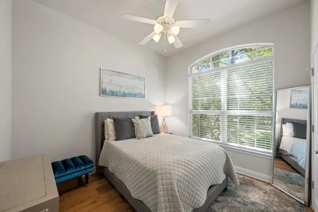 a bedroom with a bed and a large window