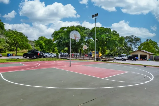 a view of a playground with basketball court