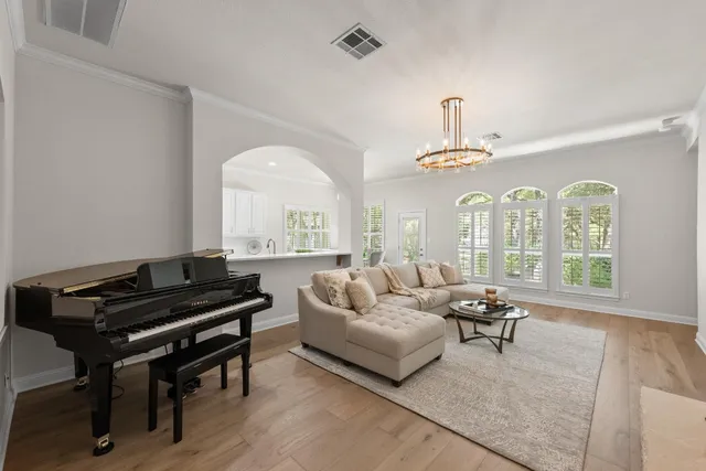 a living room with furniture fireplace and a large window