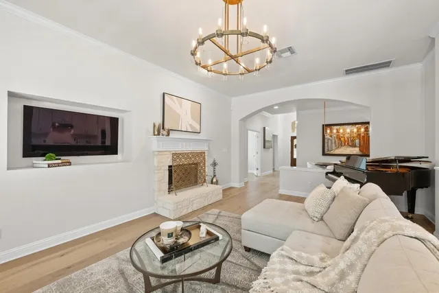 a living room with furniture a flat screen tv and kitchen view