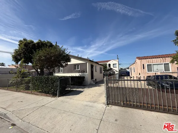 a view of a house with backyard and sitting area