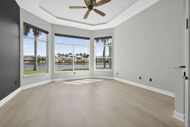 an aerial view of residential houses with outdoor space and lake view