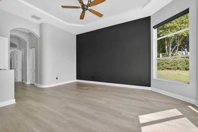 an aerial view of residential houses with outdoor space and trees