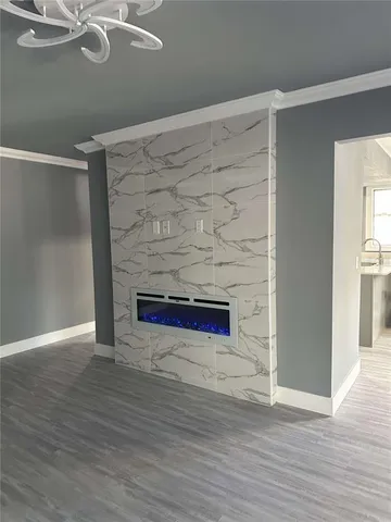 a room with a wooden floor and a fireplace