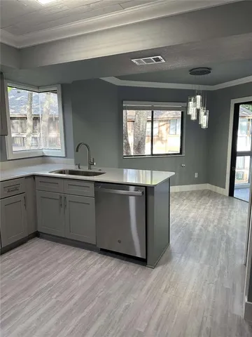 a kitchen with a sink cabinets and window