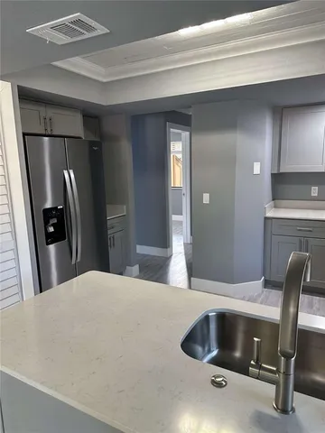 a kitchen with a sink cabinets and appliances