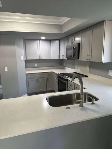a kitchen with a sink and cabinets