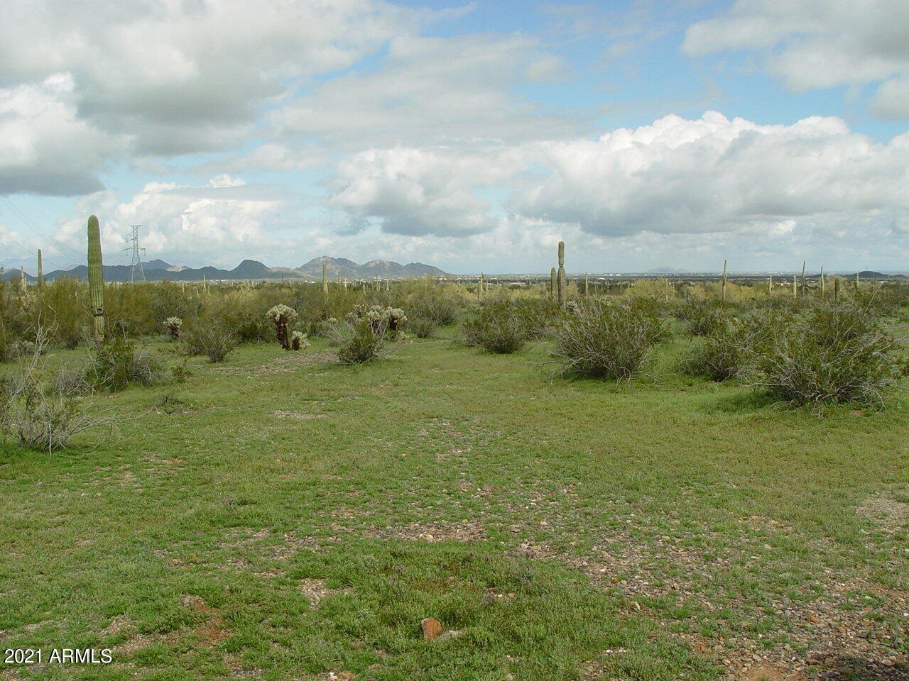 54214 West Whirly Bird Road, Unit 32 Maricopa, AZ 85139 - Photo 19 of 25 a view of a lake with houses in the back