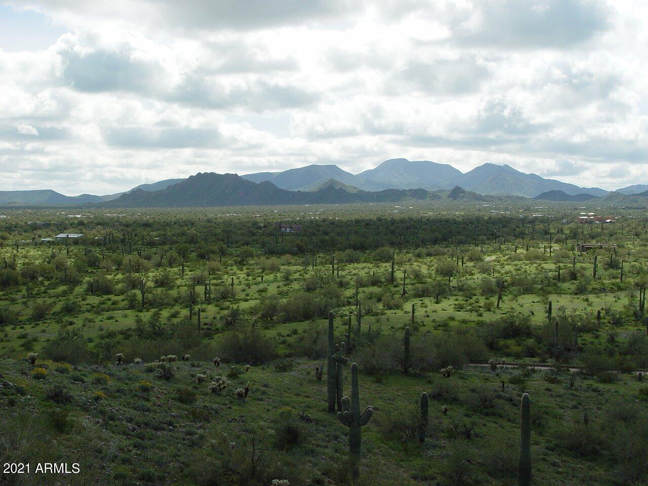 54214 West Whirly Bird Road, Unit 32 Maricopa, AZ 85139 - Photo 8 of 25 a view of a mountain with lake in background