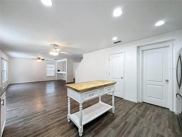 a view of a room with wooden floor wooden floor and windows